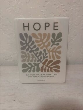 "Hope" White ceramic book vase with vertical ribbed texture.